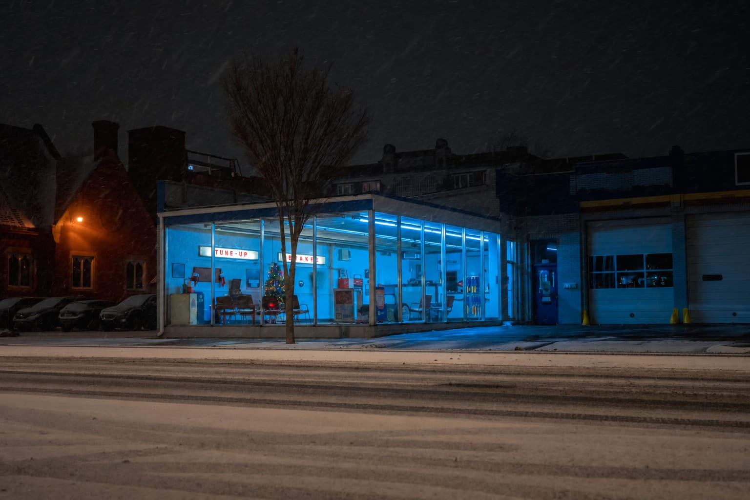 After hours phone message for a service business: an auto repair shop lit up on a snowy night