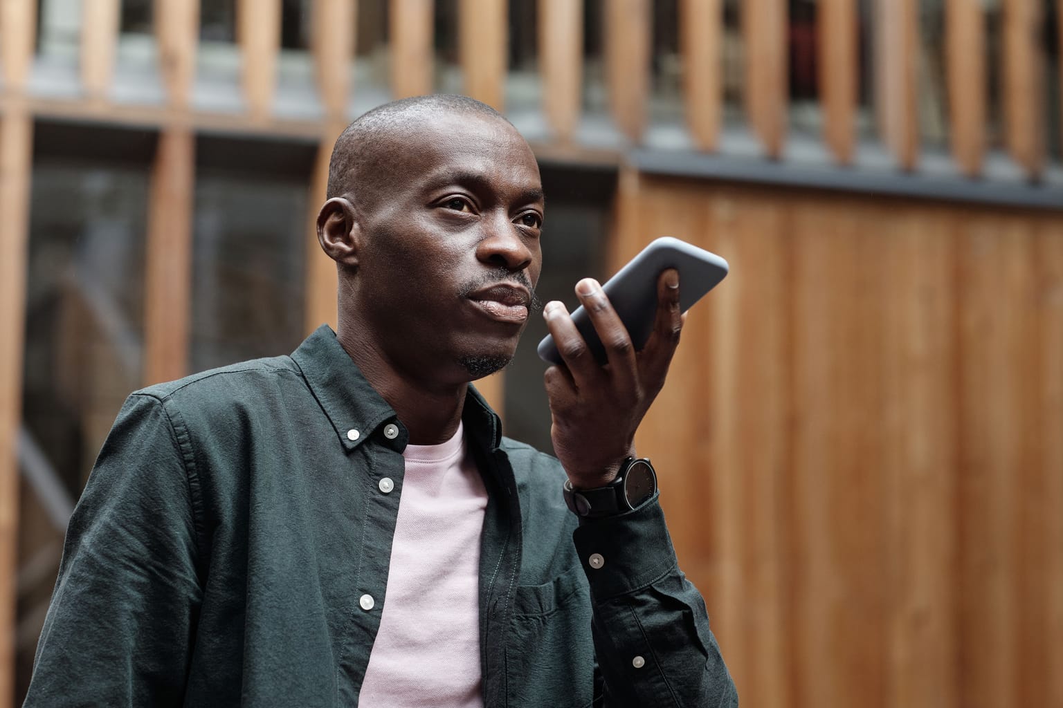 A man recording a voice message on his phone