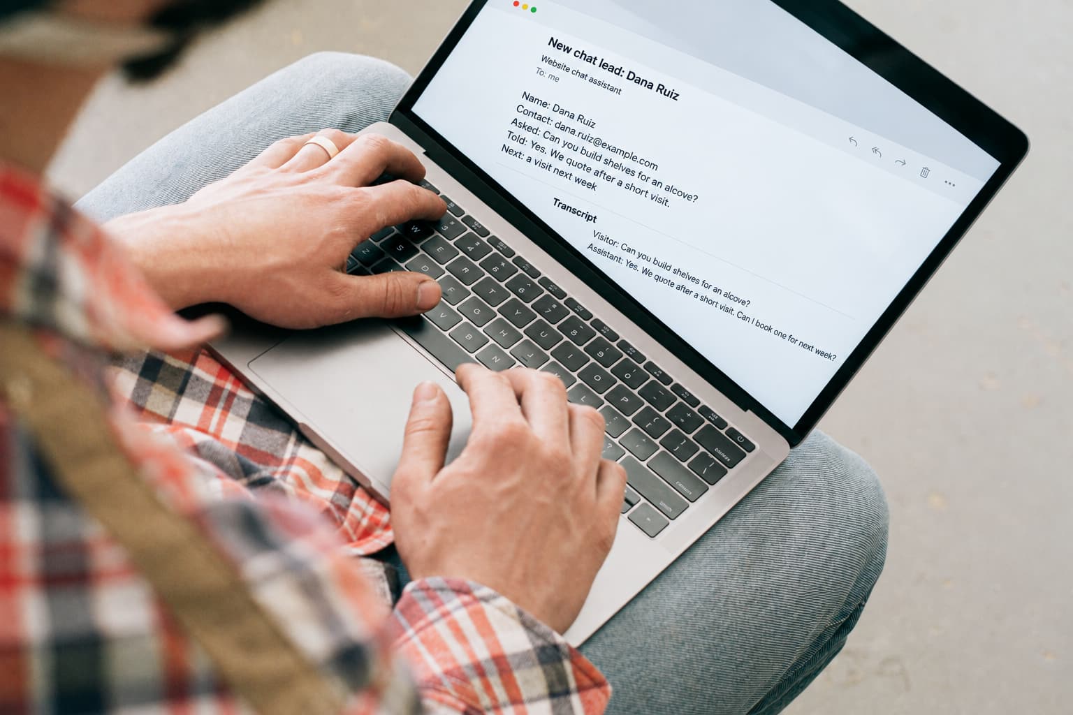 A carpenter's laptop showing one email for a chat lead, with the visitor's name, contact, question, the answer given and the next step