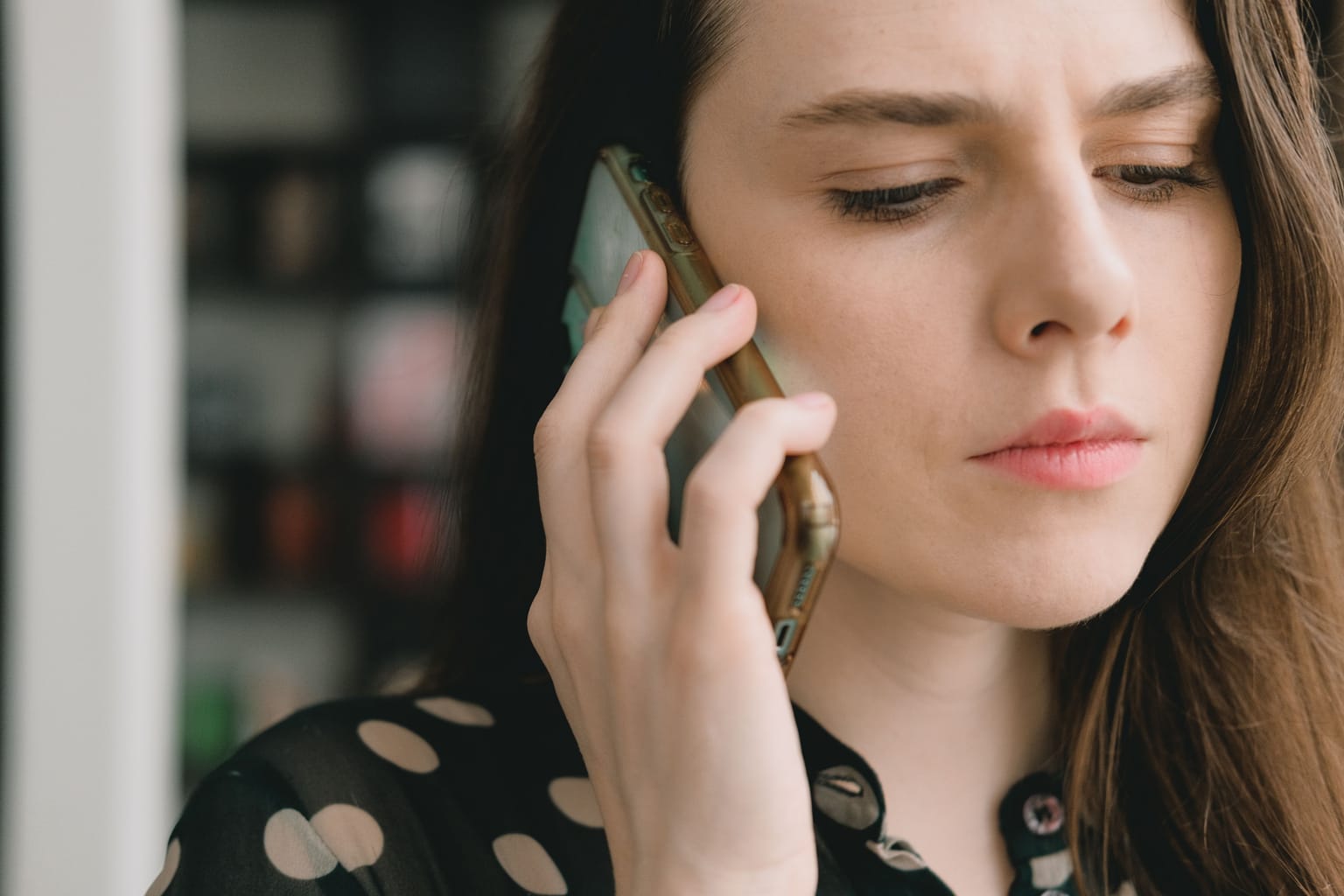 Do callers hang up on AI receptionists: a caller listening closely on the phone, deciding whether to stay on the line