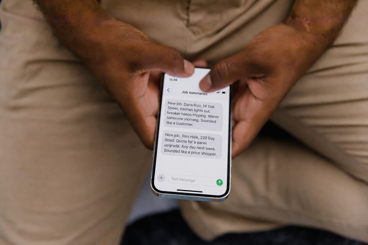 A tradesperson's phone showing two job summaries: a customer with a tripping breaker who wants tomorrow morning, and a price shopper after a quote for a panel upgrade