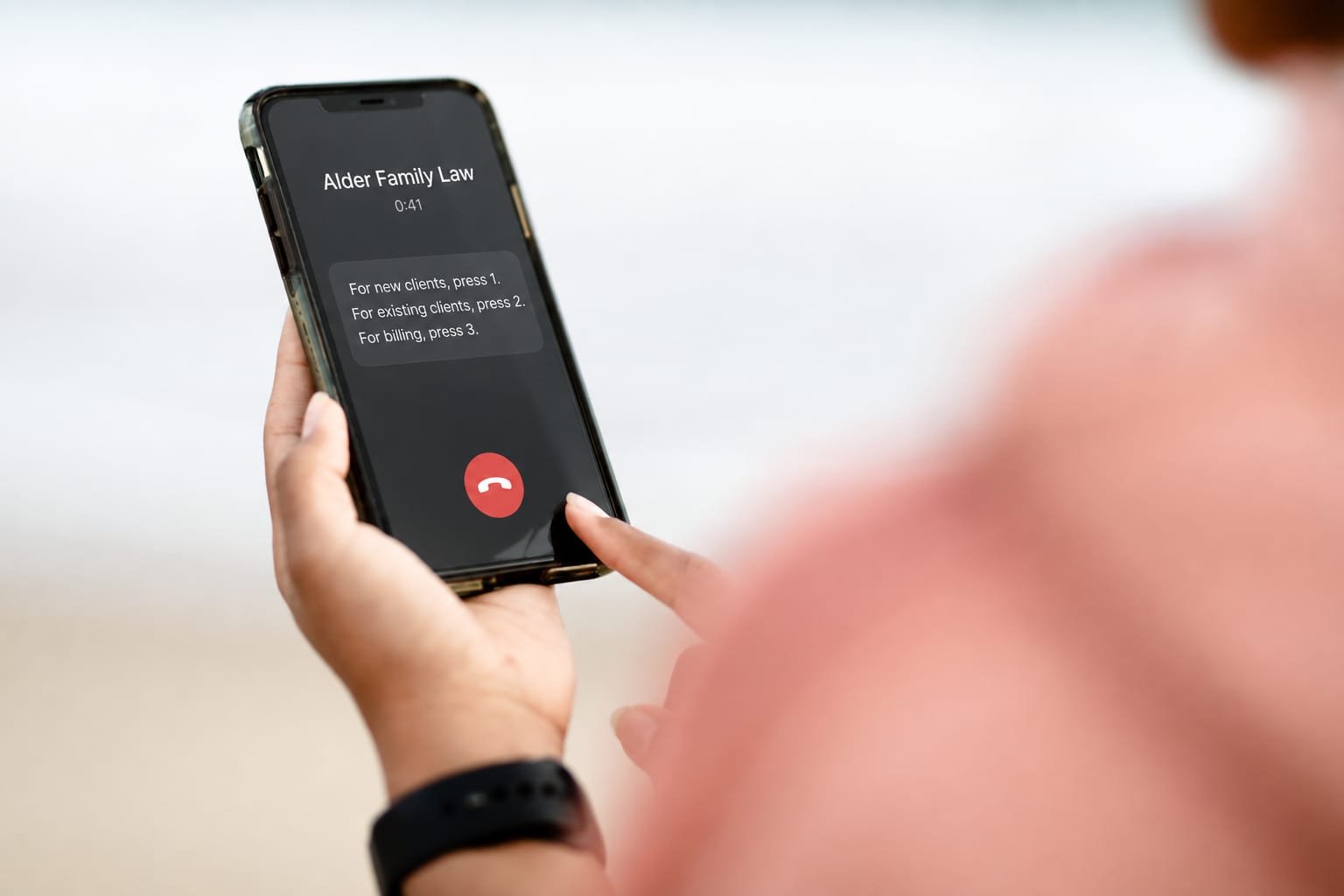 A caller's thumb on the end-call button while a law firm's phone menu reads out its options