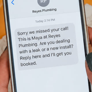 A text from Reyes Plumbing that begins: Sorry we missed your call!