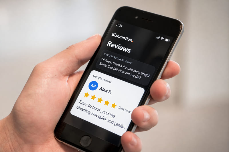 A phone showing the review request sent to Alex and his new five-star Google review, marked Just now.